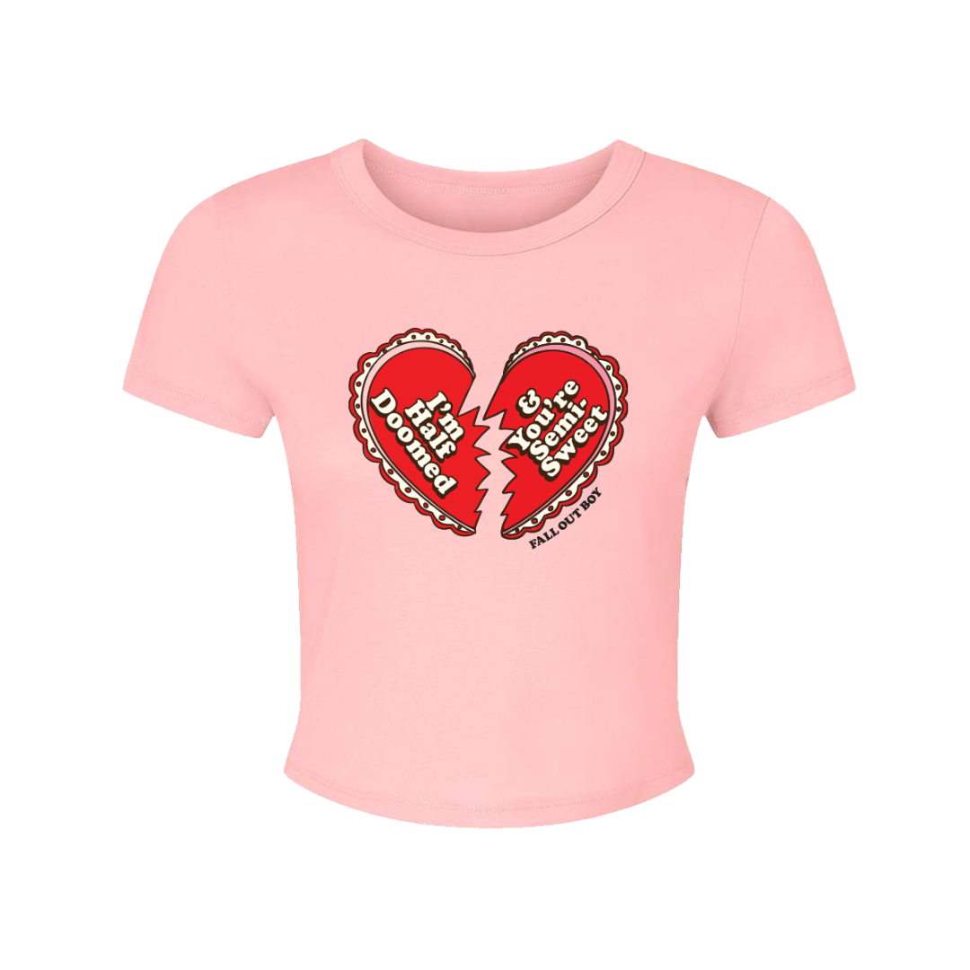A soft pink cropped t-shirt with a red broken heart graphic and fall out boy text from official fall out boy uk merchandise